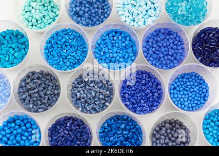 different blue plastic resin granulates for injection moulding process in different granulate types Stock Photo