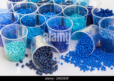 different blue plastic resin granulates for injection moulding process in different granulate types Stock Photo