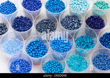different blue plastic resin granulates for injection moulding process in different granulate types Stock Photo