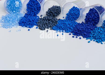different blue plastic resin granulates for injection moulding process in different granulate types Stock Photo