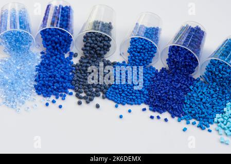 different blue plastic resin granulates for injection moulding process in different granulate types Stock Photo