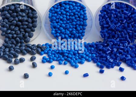 different blue plastic resin granulates for injection moulding process in different granulate types Stock Photo