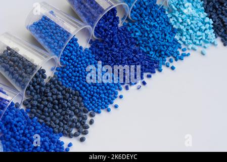 different blue plastic resin granulates for injection moulding process in different granulate types Stock Photo