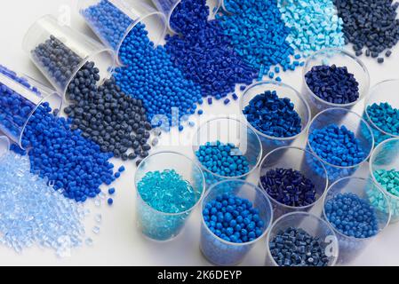 different blue plastic resin granulates for injection moulding process in different granulate types Stock Photo