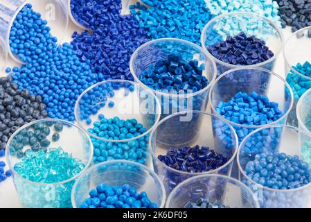 different blue plastic resin granulates for injection moulding process in different granulate types Stock Photo