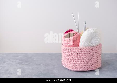 Crochet basket with handcraft tools for knitting and crocheting with copy space Stock Photo