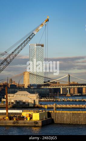 view from New York Harbor towards Brooklyn and Manhattan bridges and One Manhattan Square skyscraper, New York City, USA Stock Photo