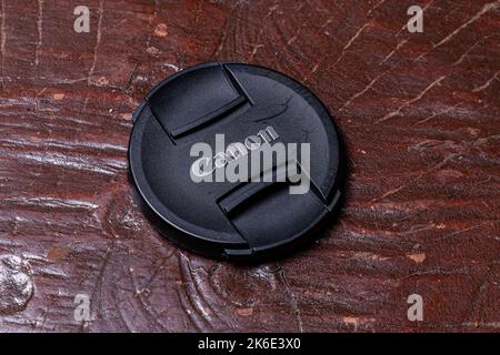 Itaja, Goias, Brazil - 09 21 2022: canon brand camera lens black cap on a wooden table Stock Photo