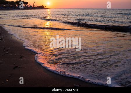 beautiful sea landscape with a sunset. evening purple sky with clouds over ocean. sea surf with waves.Bright and dynamic sea beach.Nature, environment Stock Photo
