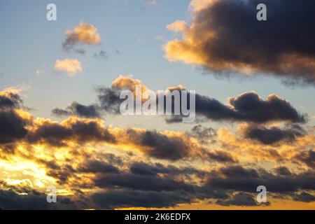 Dark clouds on clear sunset sky Stock Photo
