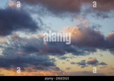 Dark clouds on clear sunset sky Stock Photo