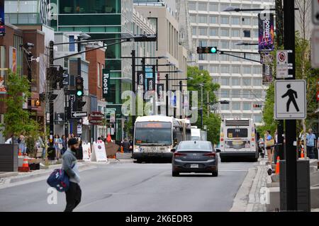 Cars and buses (Halifax Transit route 1) on the Spring Garden commercial shopping street in Halifax, Nova Scotia, Canada Stock Photo