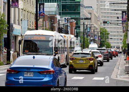 Cars and buses (Halifax Transit route 1) on the Spring Garden commercial shopping street in Halifax, Nova Scotia, Canada Stock Photo