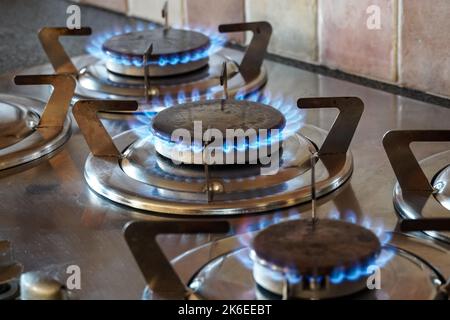 Blue gas flames burning on a gas hob burner, kitchen gas cooker Stock Photo