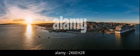 Aerial panoramic view of Praca do Comercio and Baixa district in Lisbon, Portugal with 25 April Bridge visible on the Tagus River Stock Photo