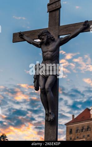 Crucifix near Cesky Krumlov castle. The statue of the crucified Jesus Christ on the cross on the Lazebnicky bridge in Cesky Krumlov, Czech Republic. Stock Photo