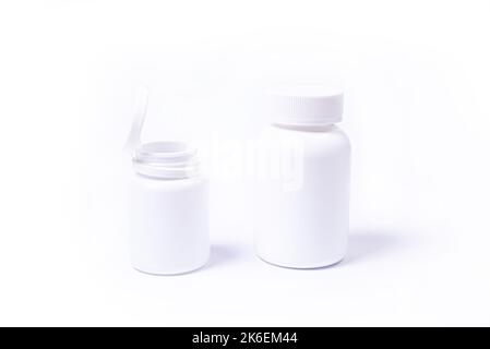 supplement pills with medicine bottle health care and medical top view. Vitamin tablets. Top view mockup bottle for pills and vitamins with green leav Stock Photo