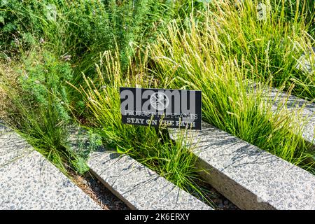 Lawn grass between decorative rail sleepers in Highline Park Manhattan Stock Photo