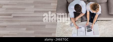 Couple Counting Finance With Calculator At Home Stock Photo