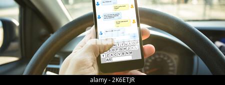Phone Texting While Driving. Man Using Mobile Phone Stock Photo
