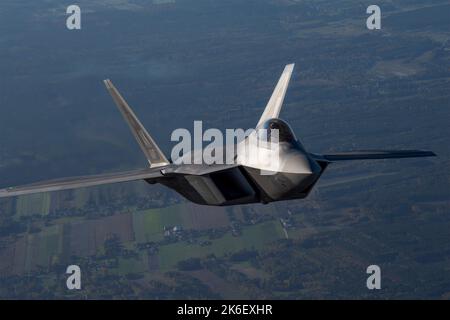 Lask, Poland. 12th Oct, 2022. A U.S. Air Force F-22 Raptor fighter aircraft assigned to the 90th Expeditionary Fighter Squadron climbs out during the NATO Air Shielding over Poland October 12, 2022 near Lask, Poland. Credit: SSgt Danielle Sukhlall/U.S Air Force/Alamy Live News Stock Photo