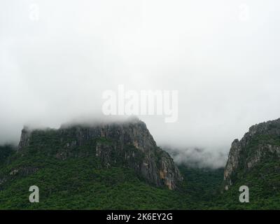 Cloud and fog cover limestone mountain in the rainy season, Green forest and rock at Khao Sam Roi Yot National Park, Thailand Stock Photo