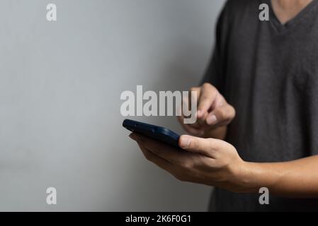 Man hand holding mobile smart phone technology communication digital. Stock Photo