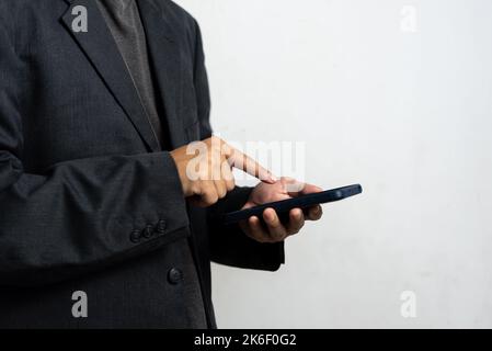 Man hand holding mobile smart phone technology communication digital. Stock Photo