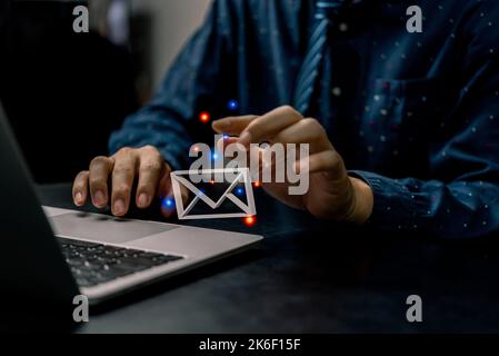 businessman using computer laptop and checking email icon 3D online or sending mail to partner and customer on web with virtual interface technology c Stock Photo