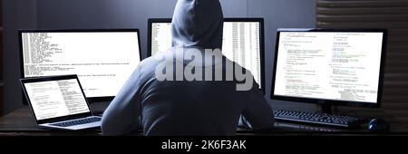 Hacker And Computer Data Breach. Cyber Risk Stock Photo