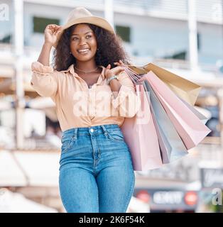 Black woman, retail shopping bag and city travel for discount sales, summer market and fashion promotion in San Francisco California. Happy, wealthy Stock Photo
