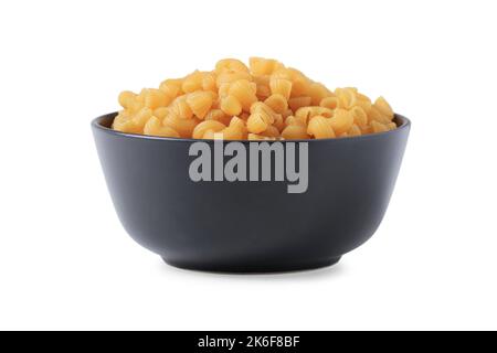 Raw pasta in black ceramic bowl isolated on white Stock Photo