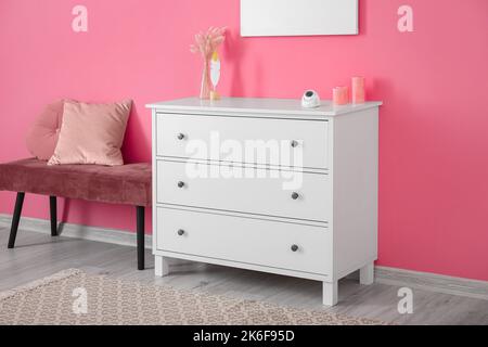 Modern security CCTV camera on chest of drawers at home Stock Photo