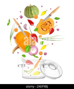 Flying fresh vegetables with knives and glass saucepot on white background Stock Photo