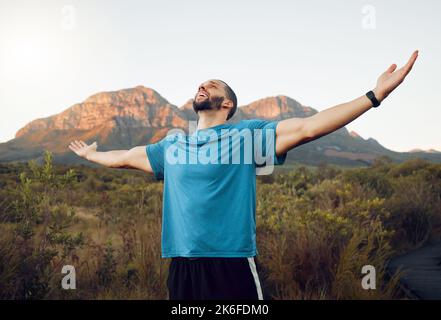 Mountain, sports man hands celebrate victory after fitness hike or climbing cardio adventure. Young happy male athlete, arms raised and wellness Stock Photo