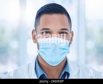 Covid, face mask and portrait of a happy doctor in a hospital working, smiling and helping with healthcare expertise. Smile, compliance and medical Stock Photo
