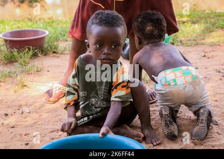 Kumasi, Ghana - April 04, 2022: African playing Children on the Village Street Stock Photo