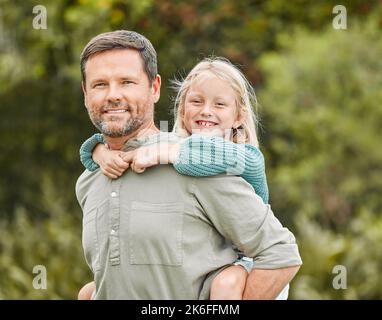 Ill carry her through life as far as she needs me to. a father spending time outdoors with his young daughter. Stock Photo