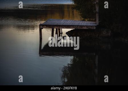 Zen atmosphere at the water's edge, on an autumn evening, at sunset. Stock Photo