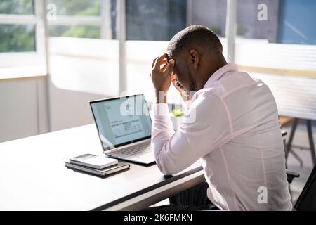 Stressed Sick African American Employee Man At Computer Stock Photo