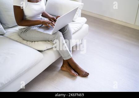 Barefoot African Woman On Floor With Underfloor Heating Stock Photo