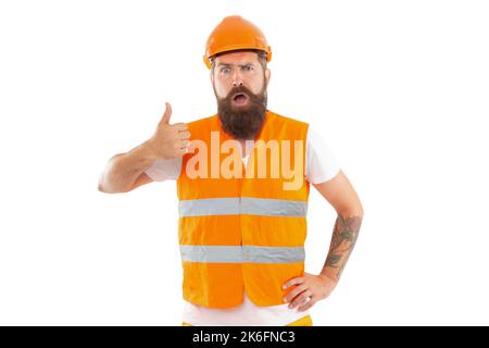 surprised worker man in uniform. bearded worker in orange vest. studio shot of worker Stock Photo