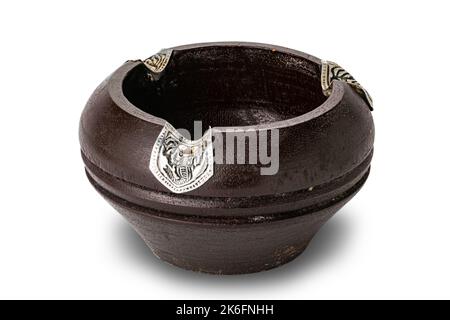 Single empty old used wooden cigarette ashtray decorated with pieces of silver isolated on white background with clipping path. Stock Photo