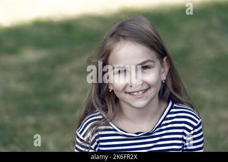 Smile that makes lasting impression. Happy child smile summer outdoors. Dental health. Oral hygiene. Cavities and teeth decay prevention. Dental Stock Photo