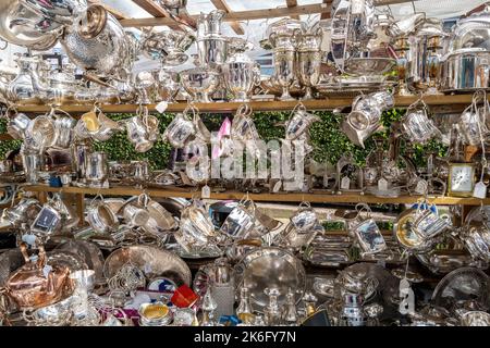 London, UK - 12 March 2022: Antique silverware for sale at a market stall in Portobello Road, Notting Hill. One of the world's largest antique markets Stock Photo