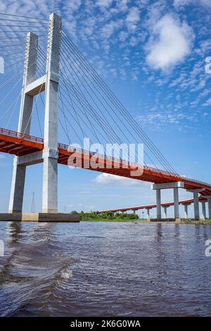 A suspension bridge spanning the Amazon river near Iquitos, Peru Stock Photo