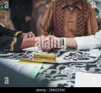 Jakarta, Indonesia, October 9th 2022 : Akad Nikah also known as marriage moment and ceremony , Indonesian Marriage called Ijab Qobul. Stock Photo