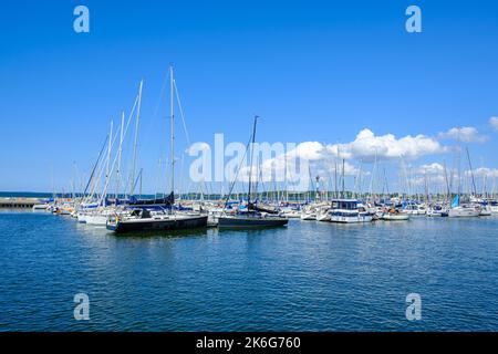 Maritime scene full of boats, mostly small sailing yachts, at the northern pier in the harbour of the Hanseatic Town of Stralsund, Germany. Stock Photo