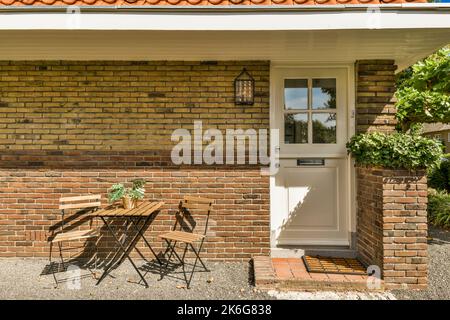 Simple small patio with small garden near fence Stock Photo