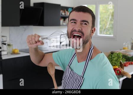 Man singing in the kitchen Stock Photo